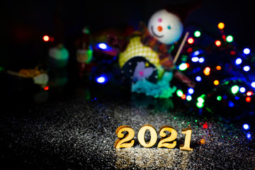 Fototapeta premium Happy New Year 2021. Symbol from number on wooden background.
