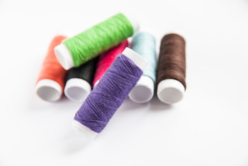 colorful spools of thread close-up on a white background