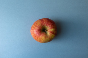 Close-up of isolated red and yellow delicious juicy apple on modern kitchen countertop