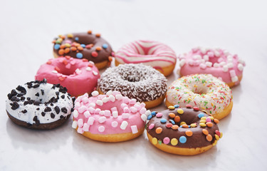mix of multicolored sweet doughnuts with sprinkles