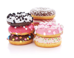 Stack of glazed doughnuts with sprinkles on white