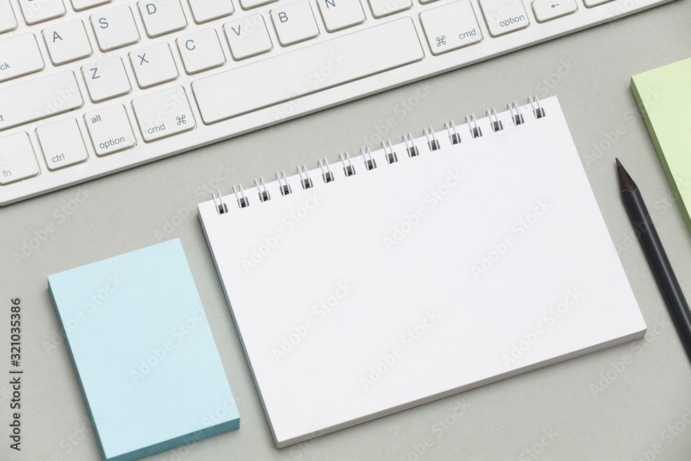 Fototapete blank notepad isolated on grey background to replace your design. side view