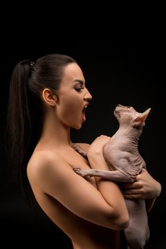 Nude girl with sphynx cat cropped portrait