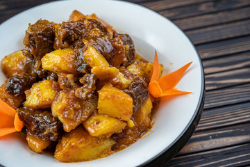 Beef stew with potatoes in a plate.
