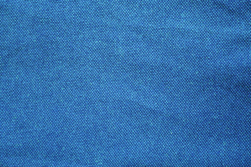 Blue fabric texture background. Vivid blue color cloth, cotton azure material, textured navy blue colorful clothing element. Fashion colorful clothes concept, simple shirt design 