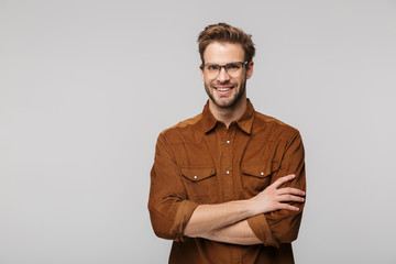 Portrait of cheerful young man posing at camera and smiling
