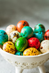 Colored Easter eggs in a bowl, closeup view