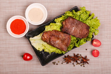 The delicious lamb ribs are roasted and cut into pieces, then put on the plate with sauce