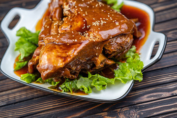 Roast pork knuckle served with boiled cabbage, bread, horseradish and mustard