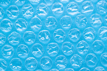 Polyethylene package material close up on the blue background. Abstract macro texture