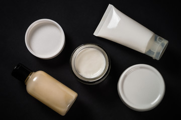 Natural cosmetics on black background.