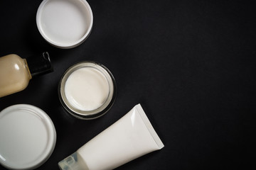 Natural cosmetics on black background.