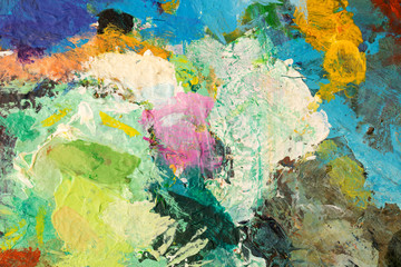 Background image of bright oil-paint palette closeup.