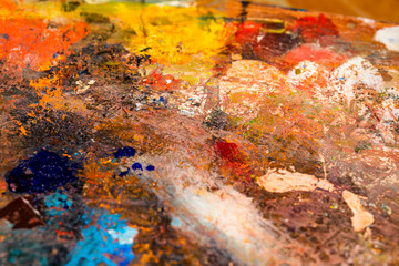Obraz na płótnie Canvas Background image of bright oil-paint palette closeup.