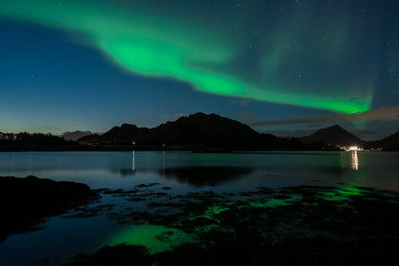 Northern lights in norway. Sea with reflection on aurora borealis