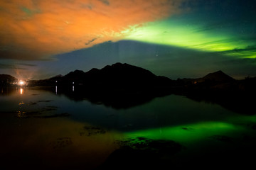 Fototapeta na wymiar Northern lights in norway. Sea with reflection on aurora borealis