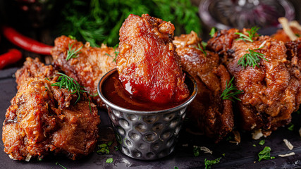 European cuisine in Ukrainian style. chicken legs and wings breaded with barbecue sauce. rustic...