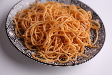 plate of spaghetti pasta with tomato