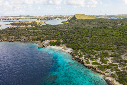 Aerial view of coast of Curaçao in the Caribbean Sea with turquoise water, cliff, beach and beautiful coral reef over Director's bay