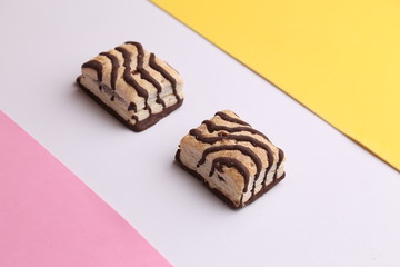 small chocolate cakes in color background