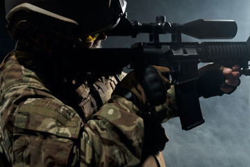 Old soldier in uniform pointing with sniper rifle.