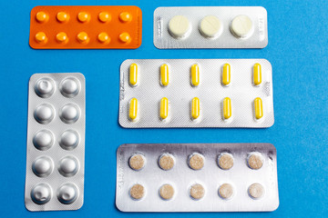 Pill set on a blue background close up