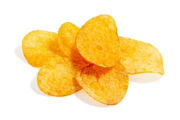 Fried potato chips isolated on white background. Delicious snack pieces of crispy golden chips. Tasty potato slices in close up. Natural organic product.