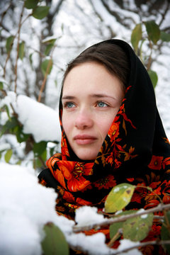 Winter portrait of white russian girl in the traditional shawl. Traditional russian beauty concept. Russian young woman portrait.