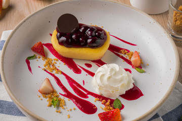 Blueberry cheese cake topping with strawberry sauces.