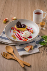 Blueberry cheese cake topping with strawberry sauces.