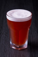 Red berry beer stand up at black background.