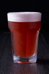 Red berry beer stand up at black background.