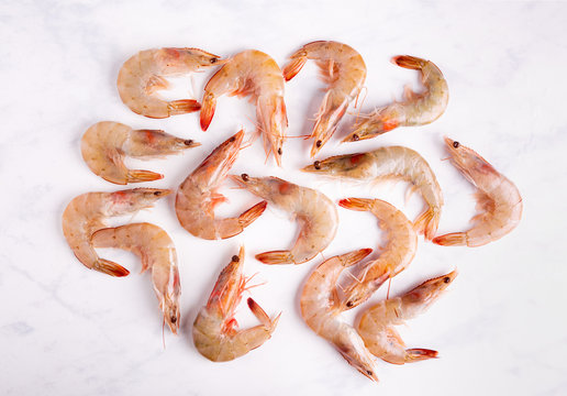 Overhead View Of Raw Unpeeled Shrimp On A Marbled Surface