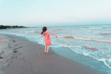 Girl dancing on the seashore.
