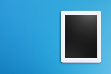 Modern digital tablet isolated on blue background with copy space