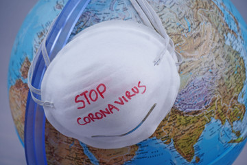 Novel coronavirus - 2019-nCoV, WUHAN virus concept. Surgical mask protective mask with CORONAVIRUS text and globe world                