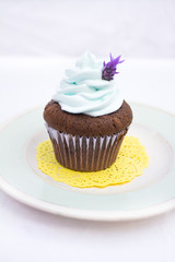 cupcake with blue icing and flowe