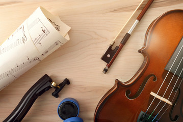 Violin and equipment on wooden table top