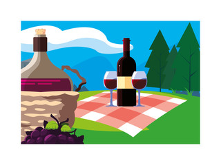 bottle of wine in wicker basket on background landscape