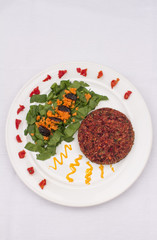 Vegan quinoa patty with salad on a plate. 