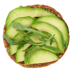 Avocado sandwich on dark rye bread with spinach isolated on white background, top view