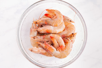 Fresh Raw Unpeeled Shrimp in a Clear Glass Bowl