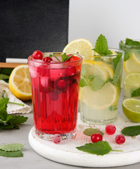 refreshing summer drink of strawberries and cranberries on a white wooden board