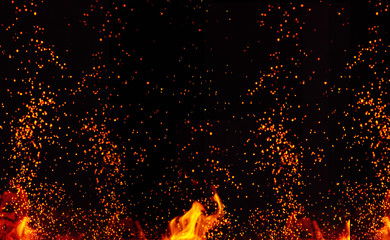Fototapeta na wymiar large burning bonfire with flame and orange sparks that fly in different directions