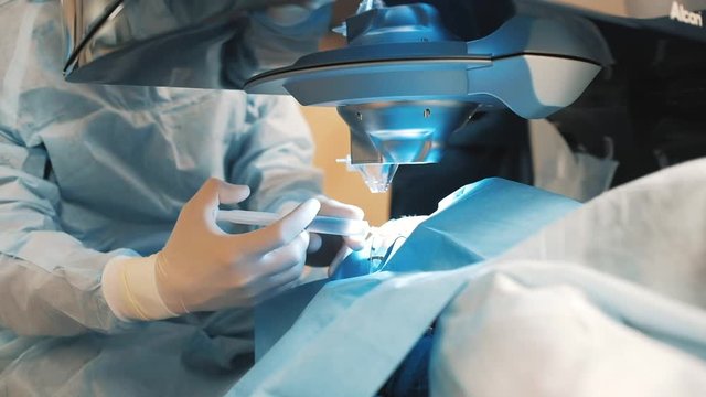 vision correction, operation. The doctor injects anaesthesia with a syringe