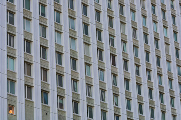 Multiple windows on a building with one illuminated