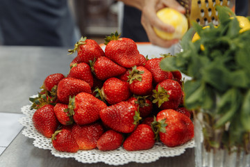 red fresh strawberries lying on the plate