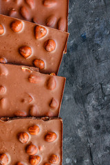 chocolate bar hazelnuts and almonds (delicious sweet dessert snack) menu concept. background. top view. copy space