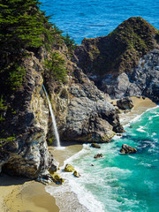 Fototapeta premium Aerial view of Water Fall McWay Falls Julia Pfeiffer Burns Park Big Sur California. McWay Falls a waterfall empties directly into the ocean.