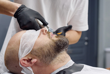beard modeling in Barber shop, beard care for men, male beauty concept